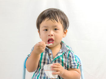 Portrait of cute boy drinking coffee