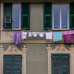 Low angle view of clothes drying against building