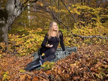Portrait of woman sitting on field