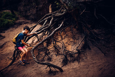 Side view of man climbing on rock