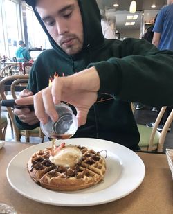 Close-up of man having food in restaurant