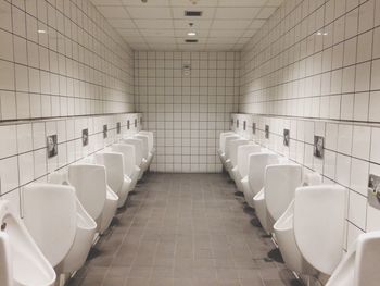 Urinals in illuminated public restroom