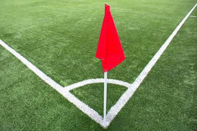 Red umbrella on grassy field