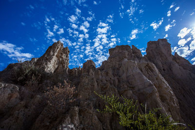 Low angle view of rock formations against sky