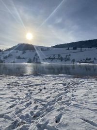 Scenic view of frozen lake against sky during winter