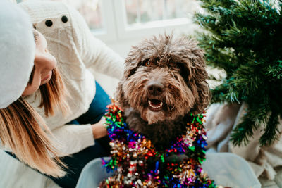 Smiling woman with dog at home