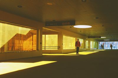 Full length of man standing in illuminated building