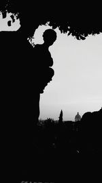 Low angle view of silhouette man against clear sky