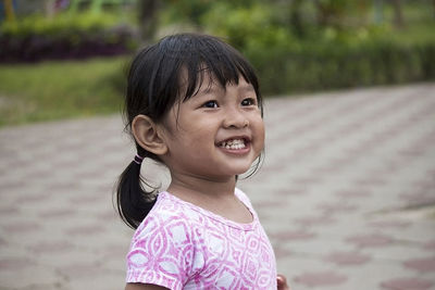 In the afternoon, a little boy was playing alone in the park, and he was laughing.