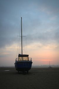 Sailboat on sea against sky during sunset