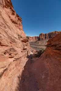 Full frame scenic view of sandstone rock formations against clear blue sky