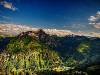 Scenic view of mountains against blue sky