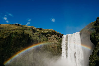 Scenic view of rainbow over river