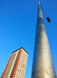 Low angle view of buildings against blue sky