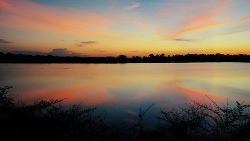 Scenic view of lake against romantic sky at sunset