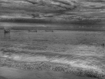 Scenic view of sea against cloudy sky