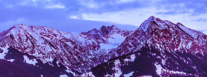 Low angle view of snowcapped mountain against sky