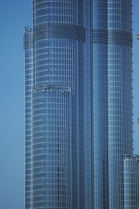 Low angle view of modern building against blue sky