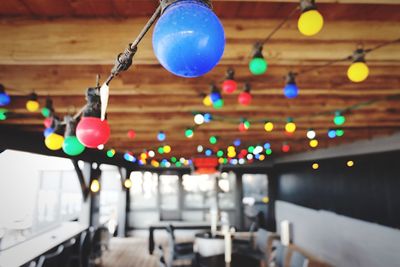 Close-up of balloons against illuminated lights