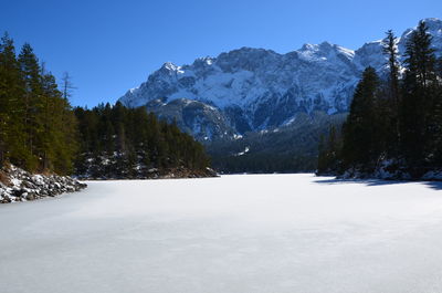 Scenic view of snow covered mountains against sky