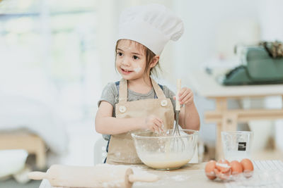 Portrait of a girl having food at home