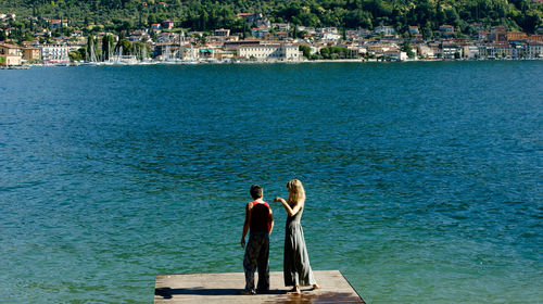 Women looking at sea in city