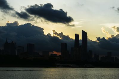 Cityscape against cloudy sky