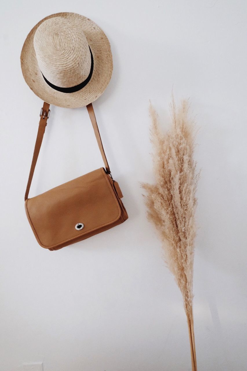 no people, wood - material, white background, studio shot, still life, hat, indoors, close-up, brown, plant, nature, wall - building feature, clothing, hanging, copy space, focus on foreground, bag, white color, directly above, kitchen utensil, personal accessory