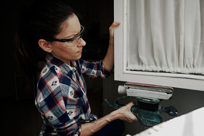 A young girl using a sander. concept of female empowerment