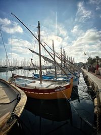 Sailboats moored in harbor