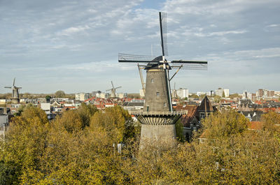 Autumn scene in dutch town with large windmills