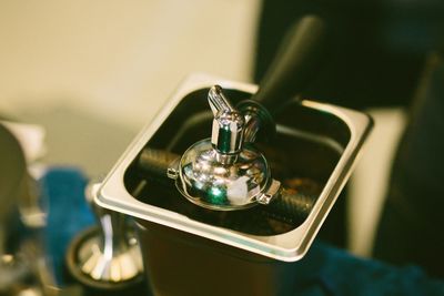 Close-up of faucet on table