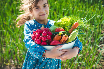 Cropped hand holding strawberries