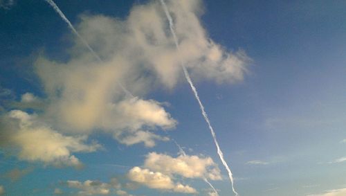 Low angle view of vapor trails in sky