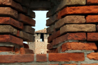 View of old building through brick wall