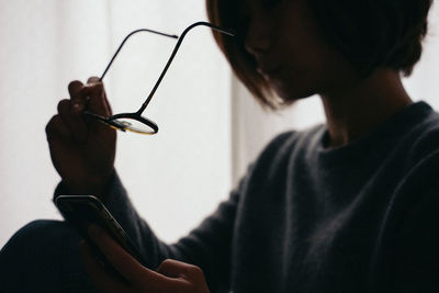 Close-up portrait of a woman using mobile phone