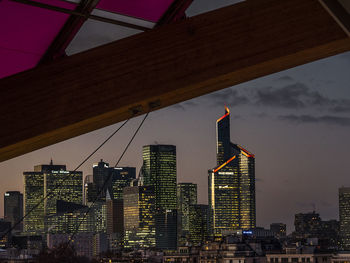 Low angle view of skyscrapers lit up at night