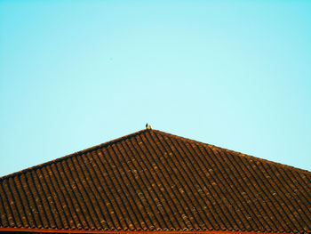 Low angle view of roof against clear blue sky