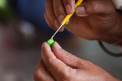 Close-up of hand holding equipment