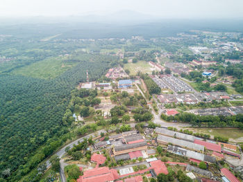 High angle view of houses in town against sky