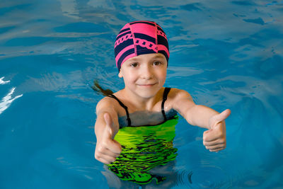 Portrait of smiling girl in swimming pool