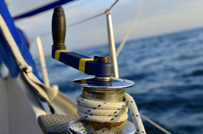 Close-up of sailboat in sea against sky