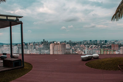 Cityscape by sea against sky