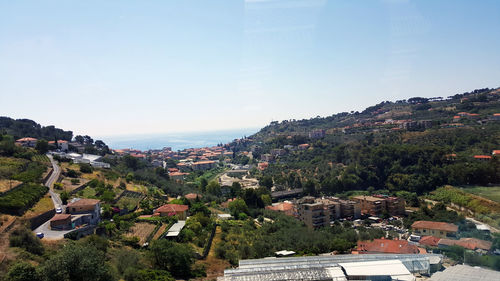 High angle view of houses in town against sky