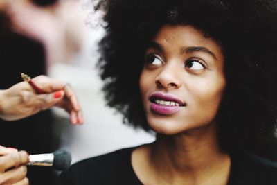 Portrait of young woman holding hair