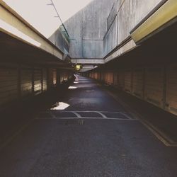 Empty road amidst buildings in city