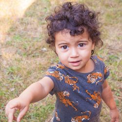 Portrait of cute boy standing in field