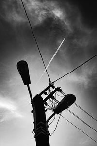 Low angle view of electricity pylon against sky