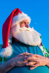 Portrait of man against blue sky