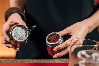 Midsection of man holding coffee cup